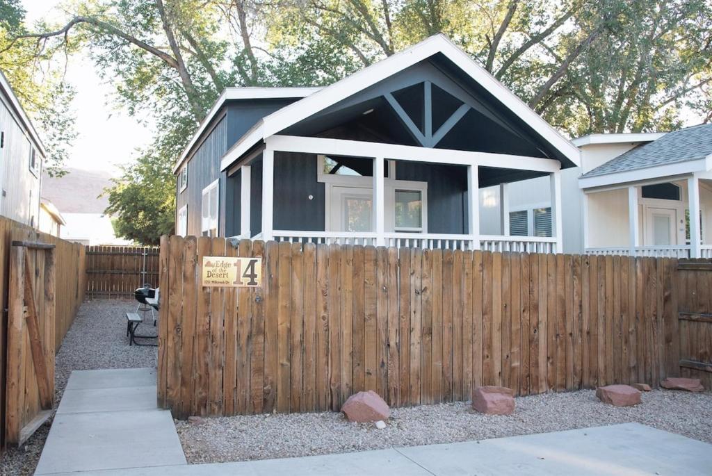 a house with a fence in front of it at Portal Overlook Cabin #14 in Moab