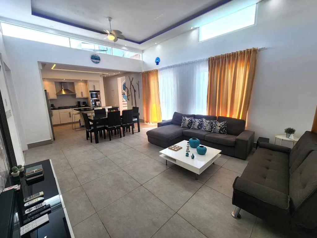 a living room with a couch and a table at Unique 3 Bedrooms Villa las Palmas 41 in Puerto Plata