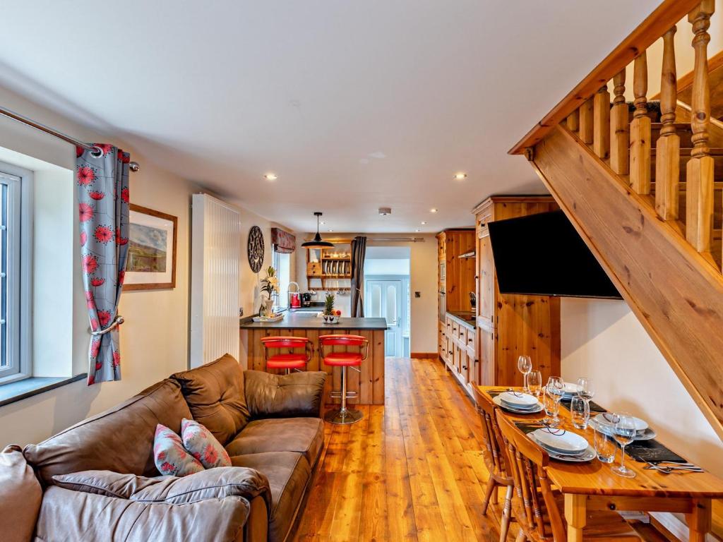 a living room with a couch and a table at 2 Bed in Ilfracombe 81464 in Ilfracombe