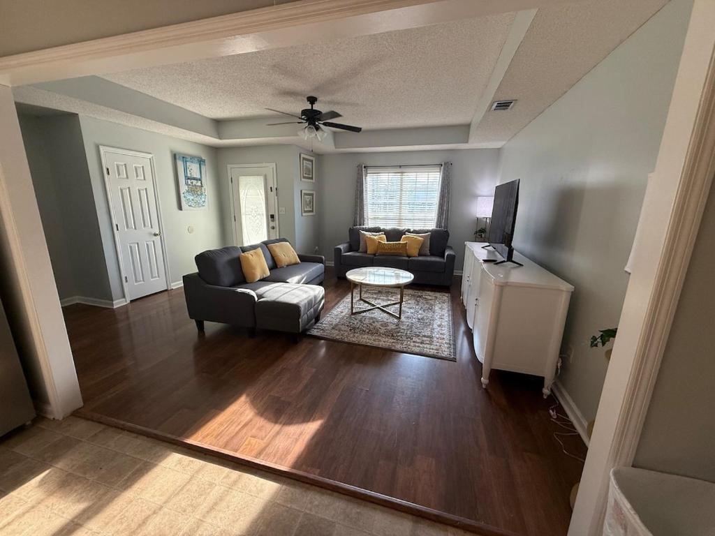 a living room with a couch and a table at Spacious 3BR Home Sleeps 12 Near Valdosta in Hahira