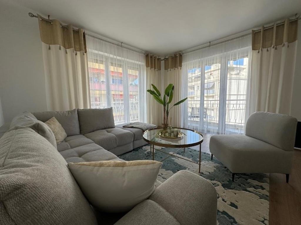 a living room with a couch and a table at Bright 1Bedroom Apartment, Steps to Juan les Pins Beach in Antibes