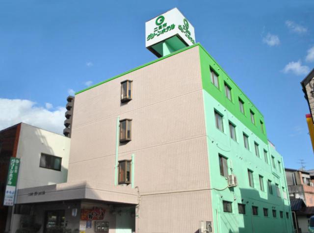 a building with a clock tower on top of it at Futsukaichi Green Hotel in Chikushino