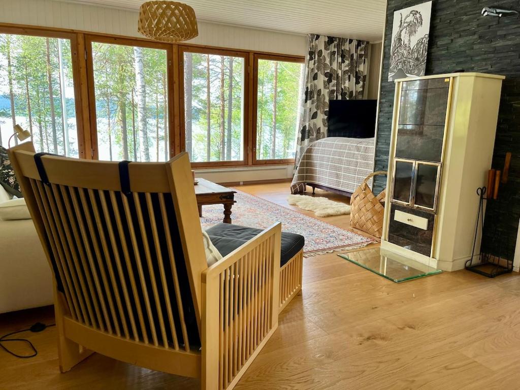 a living room with a chair and a fireplace at Lumossa Aurora Lakeside House in Rovaniemi