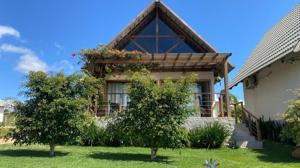 a house with a window with a flower box on it at Chalé I - Village da Serra in Serra de São Bento