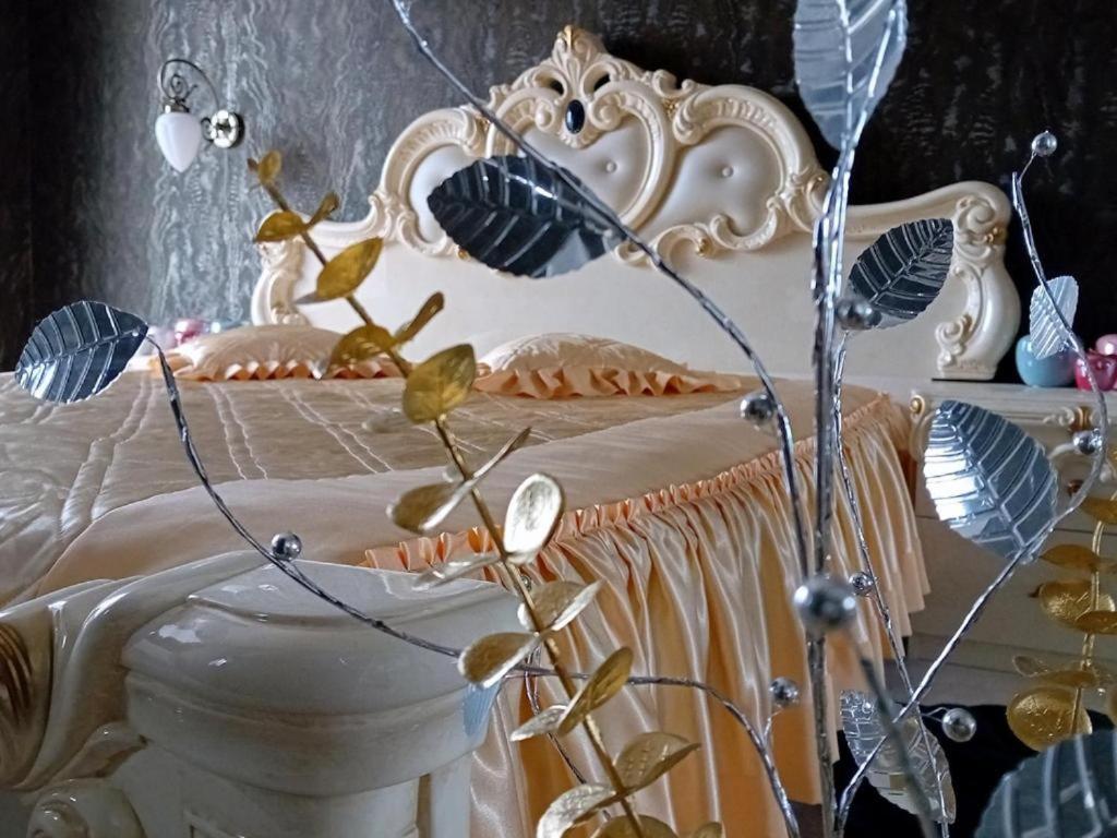 a white bed with flowers on top of it at Apartament Rajski-Parking, Taras, Vat, Targi 2km in Kielce