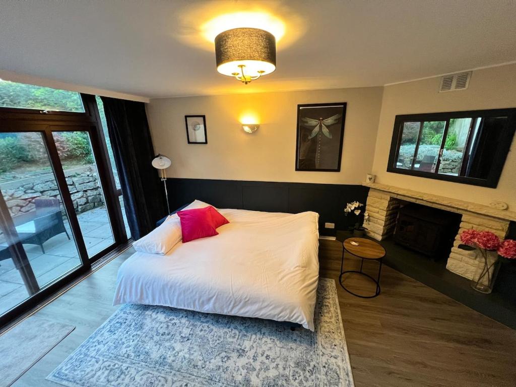 a bedroom with a large bed with a fireplace at Countryside Annexe in Felton