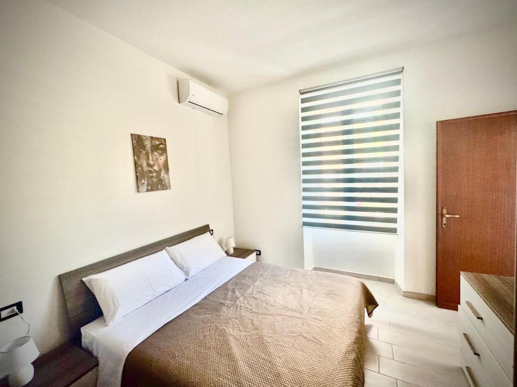 En eller flere senge i et værelse på Santa Marinella Homes Casa 5