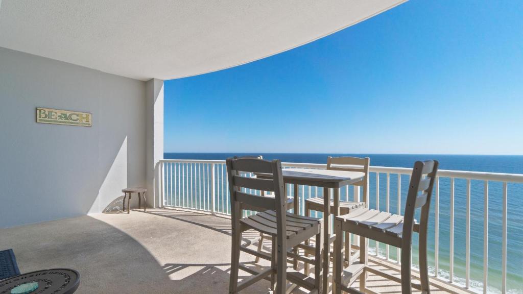 a balcony with two chairs and a table and the ocean at Island Royale P202 in Gulf Shores