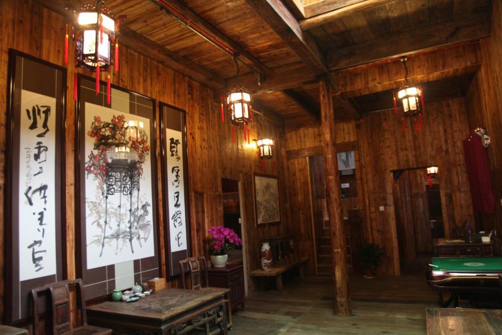 a room with wooden walls and a pool table at Old Street Xi'an Inn (Free Pick up Service) in Huangshan