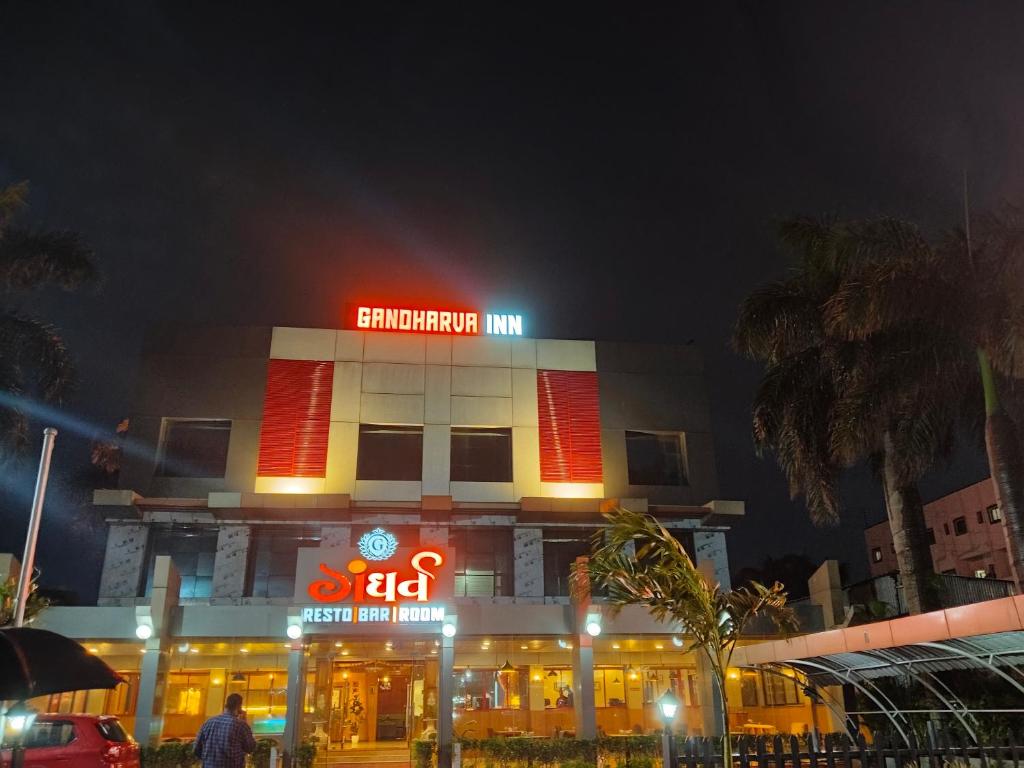 a building with neon signs in front of it at Gandharva Inn in Chakan