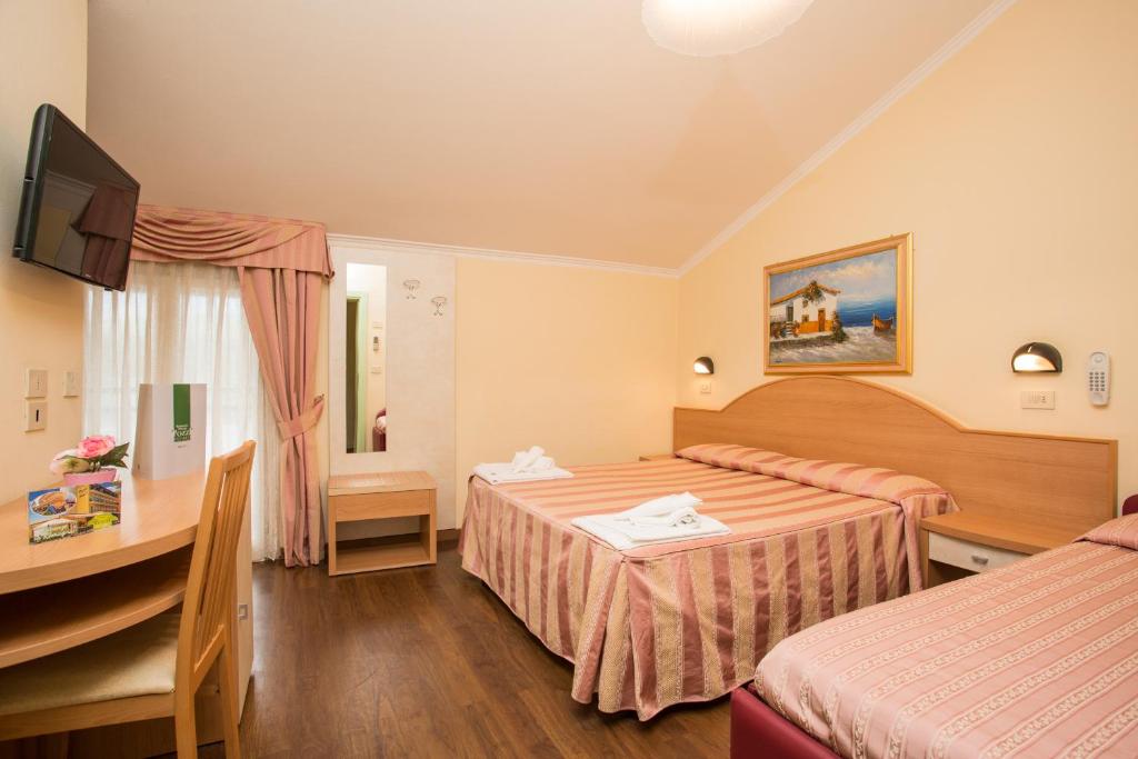 Postel nebo postele na pokoji v ubytování Albergo Ristorante Pozzi