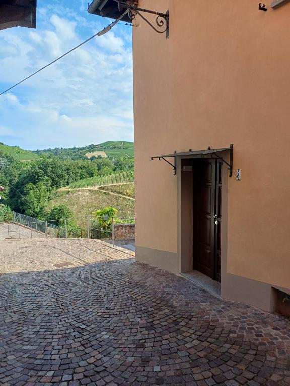 a building with a door and a brick road at Da Ciro e Angela in Barolo