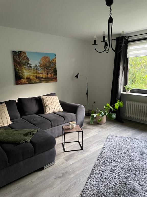 a living room with a couch and a table at Ferienwohnung Appartement am Wildpark Bad Harzburg in Bad Harzburg