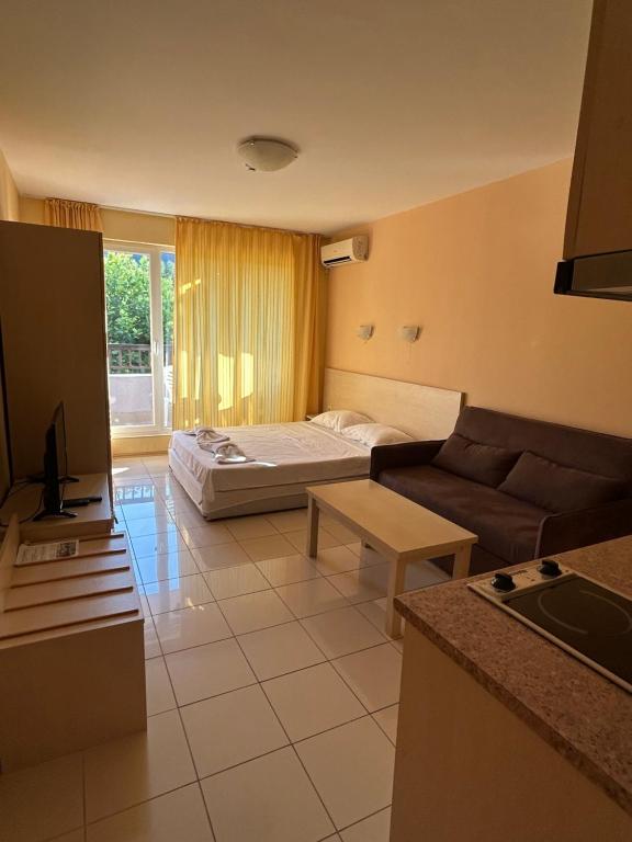 a living room with a couch and a bed at Harmony Hills Tomovi Apartament G24 in Rogachevo