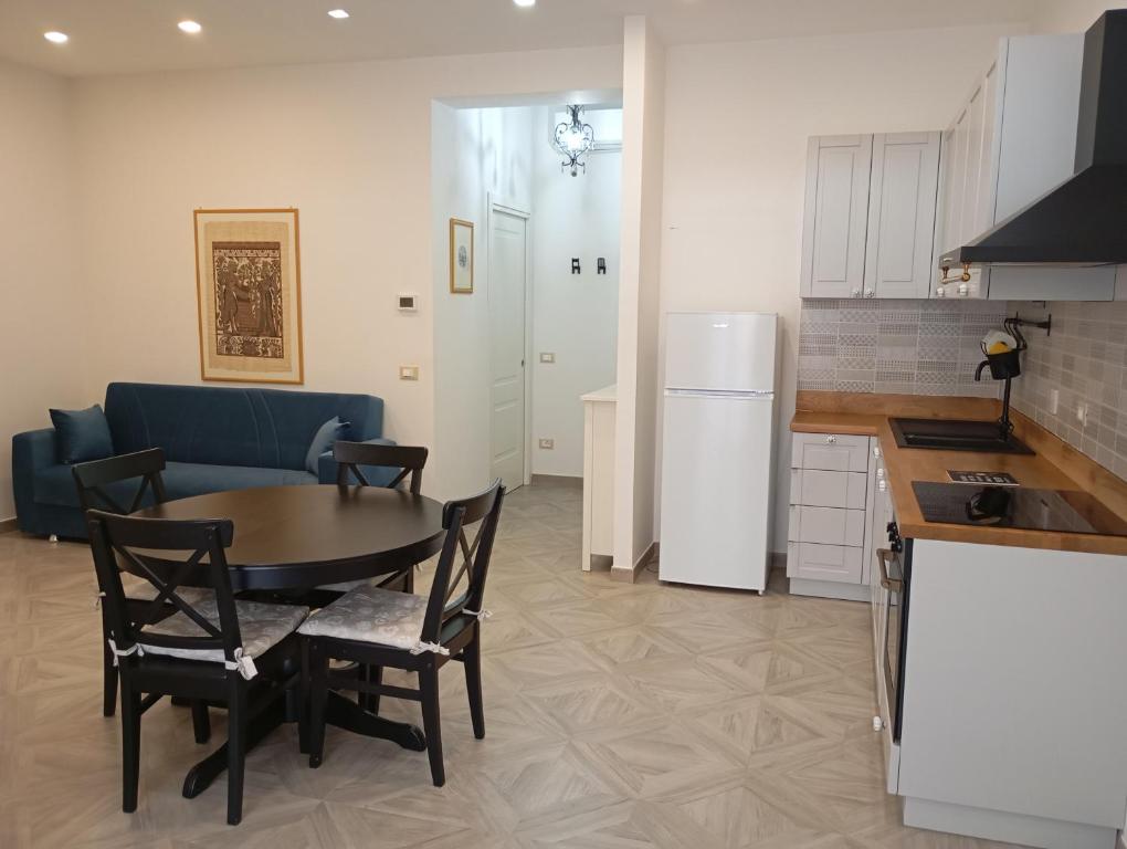 a kitchen and dining room with a table and a refrigerator at Casa Isotta in Fondi