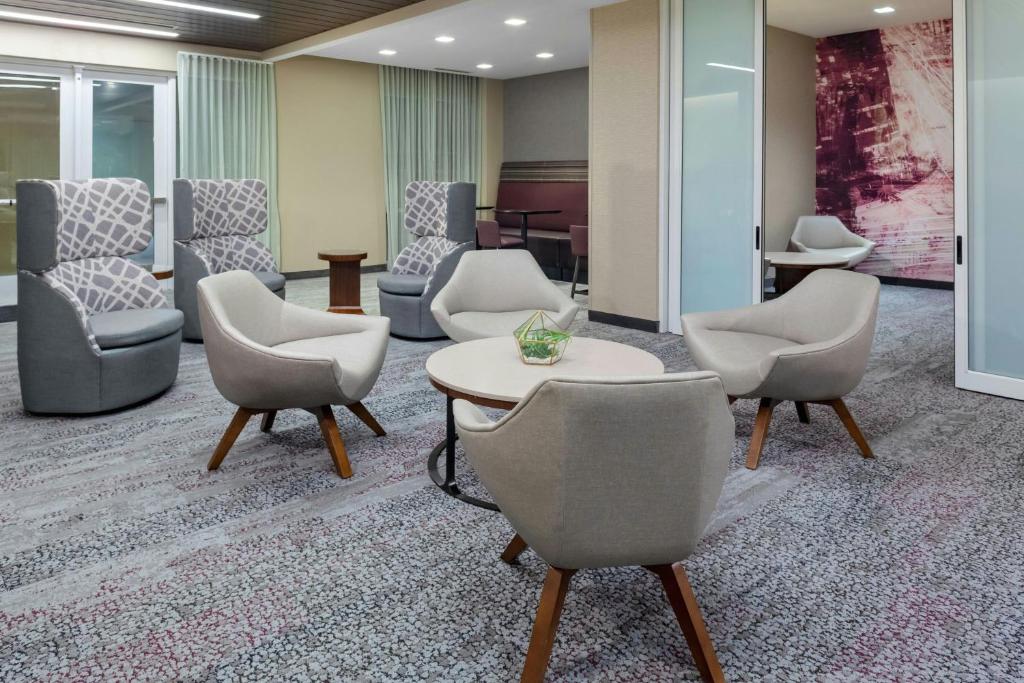 a waiting room with chairs and a table at Courtyard by Marriott St. Louis West County in Saint Louis
