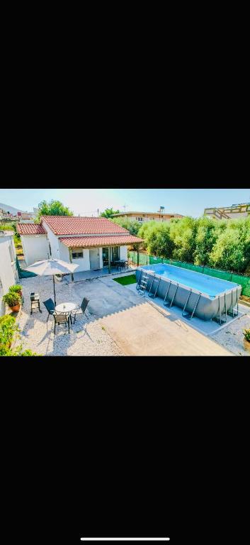 a picture of a swimming pool and a house at Cretan Blue Bungalow Chania in Chania
