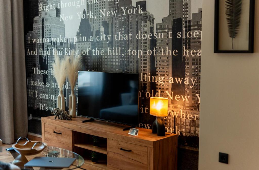 a living room with a television on a dresser at DIVINUS Luxury Stay in Markopoulo