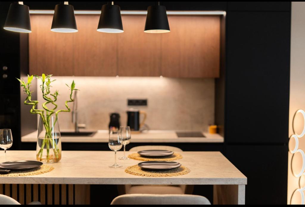 a kitchen with a table with glasses of wine at DIVINUS Luxury Stay in Markopoulo