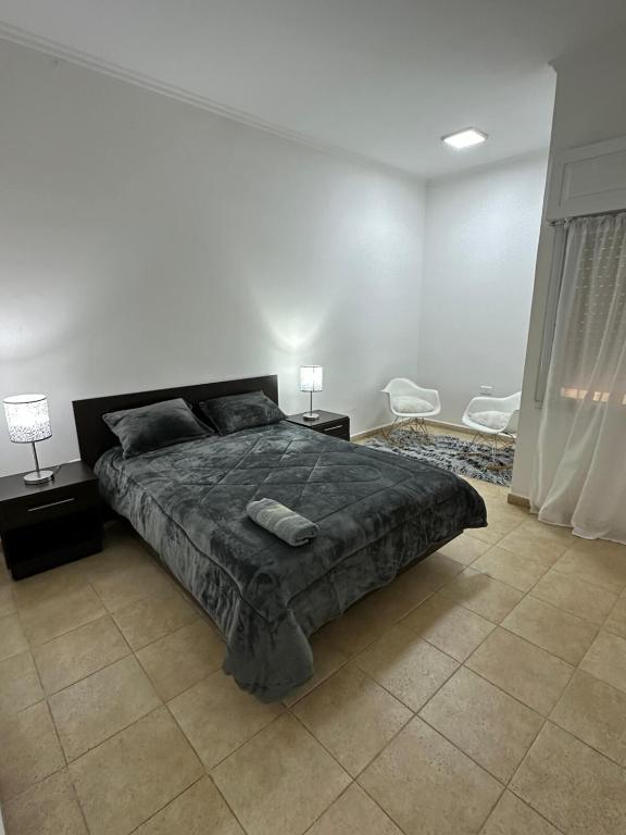 a bedroom with a large bed and two night stands at Departamento en Microcentro in Resistencia