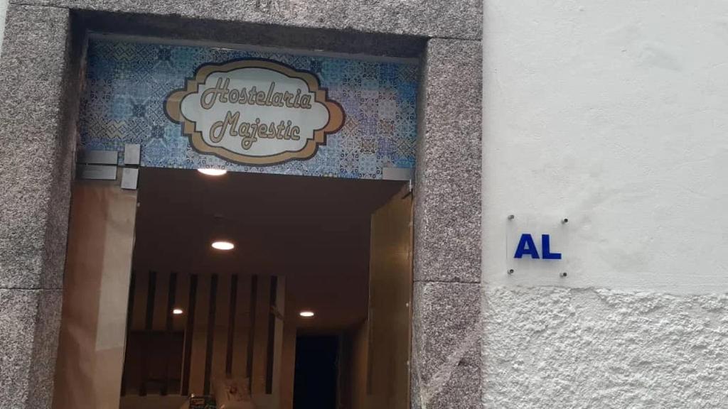 a sign on the side of a building at Majestic Hostel Porto in Porto