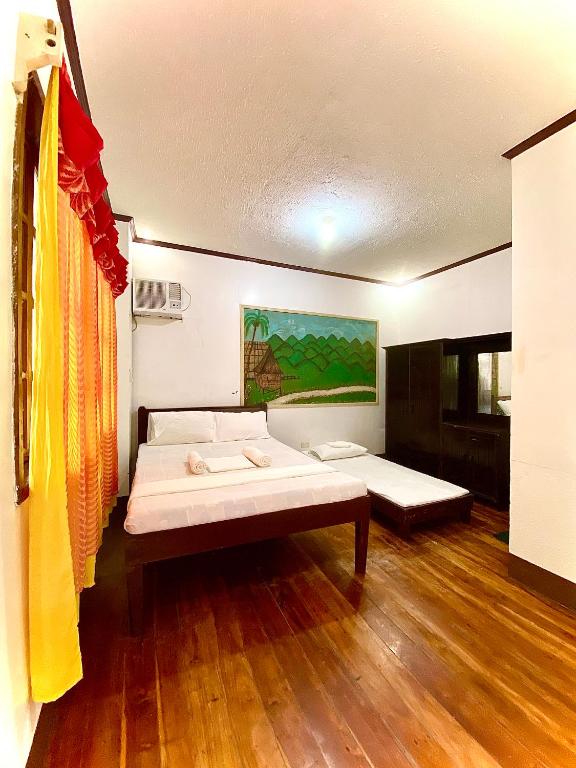 a room with a bed and a couch in it at Jala Beach Resort in Loay