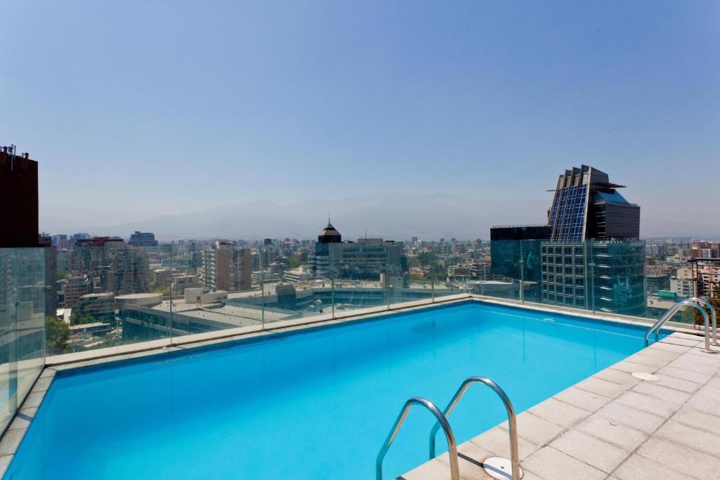 a large swimming pool on the roof of a building at City Inn Apart Home in Santiago
