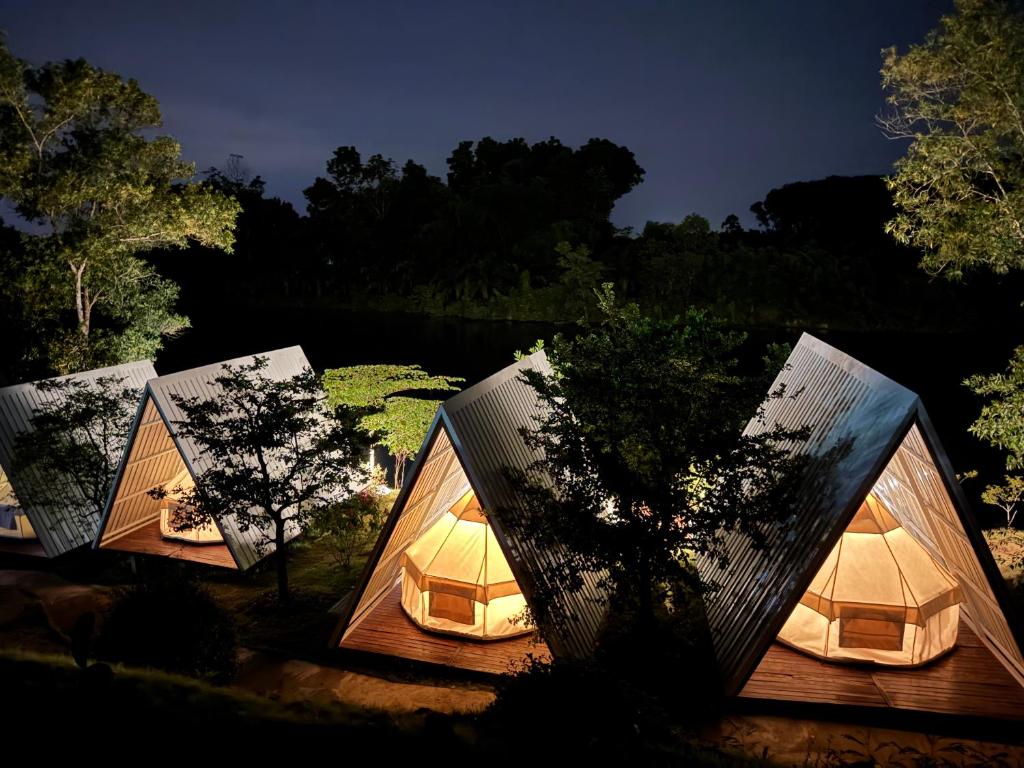 a group of tents with lights on them at Muengtaboon Camping Park in Thung Yai