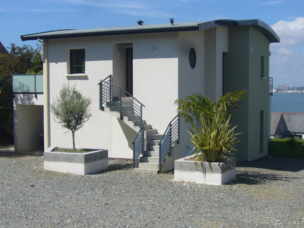 a house with stairs and plants in front of it at kermajo in Plougastel-Daoulas