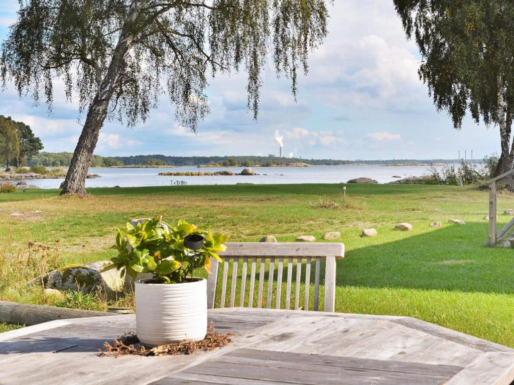 a white vase sitting on a table with a plant at 4 person holiday home in SÖLVESBORG in Björkenäs