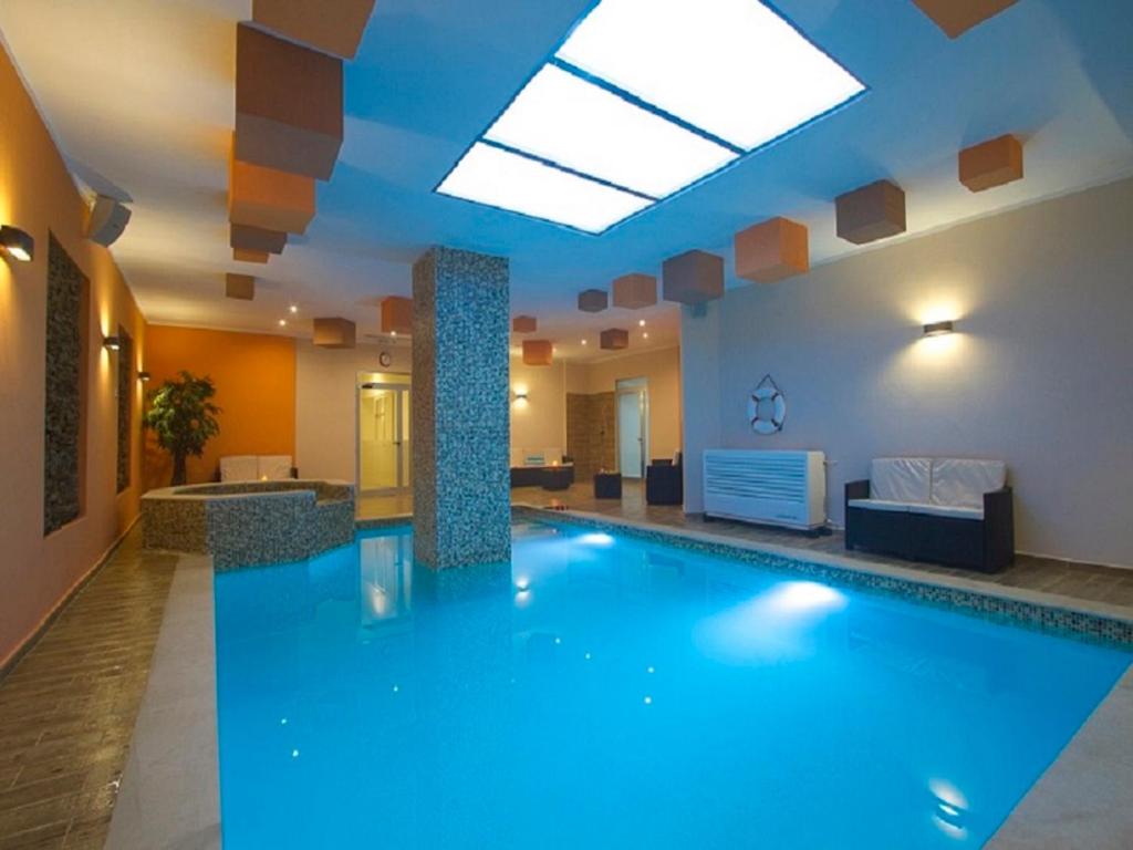a large swimming pool in a hotel lobby at Belle Apartments in St Julian's