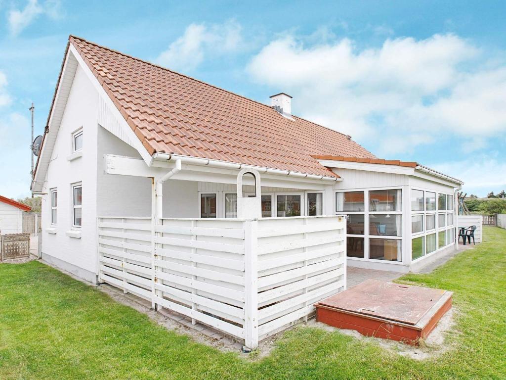 a white house with a red roof at 10 person holiday home in Thisted-By Traum in Klitmøller