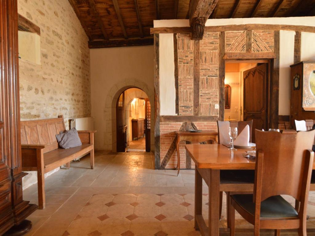 a living room with a table and a couch at Holiday Home in Thurageau with Private Pool in Boussageau