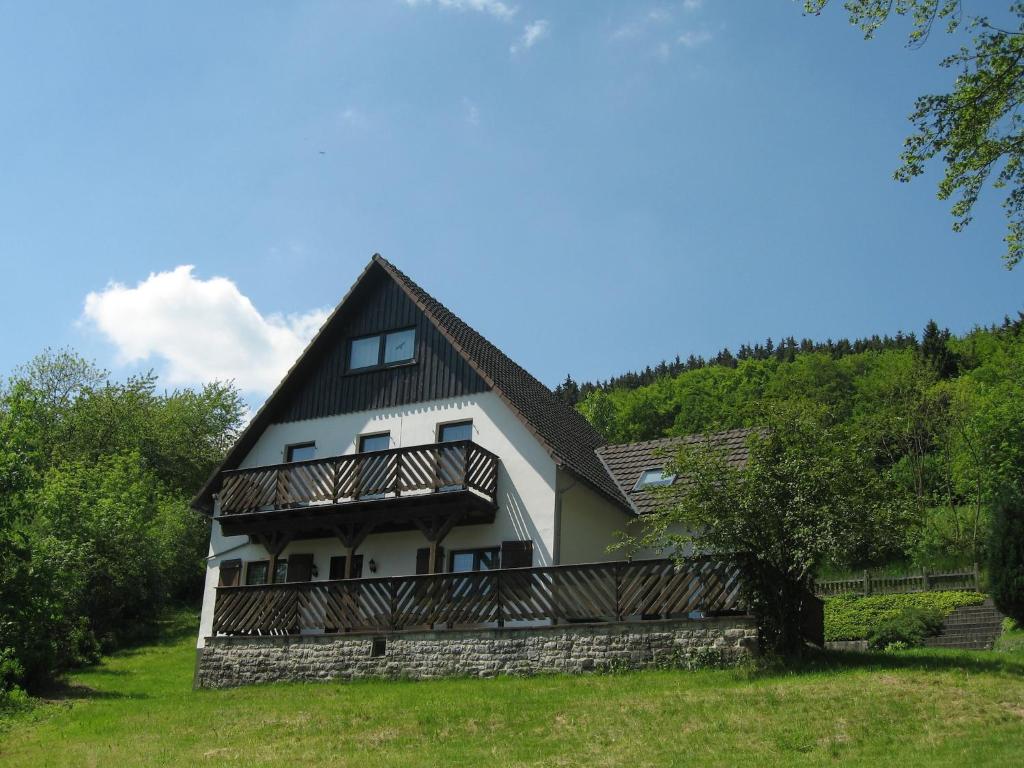 a large white house with a gambrel roof at Ferienhaus mit Weitblick bei Medebach in Medebach