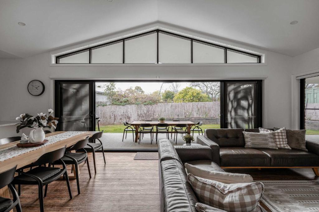 a living room with a couch and a table at Luxury On Lakeside in Mount Beauty