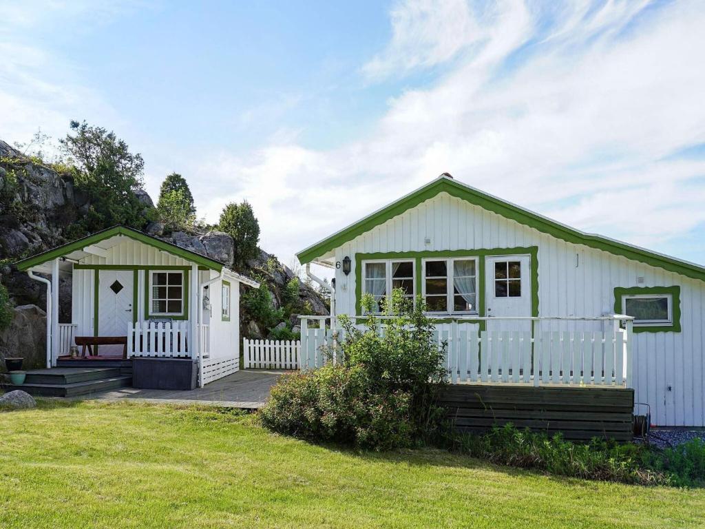 a small white house with a white fence at 4 person holiday home in STRÖMSTAD in Strömstad