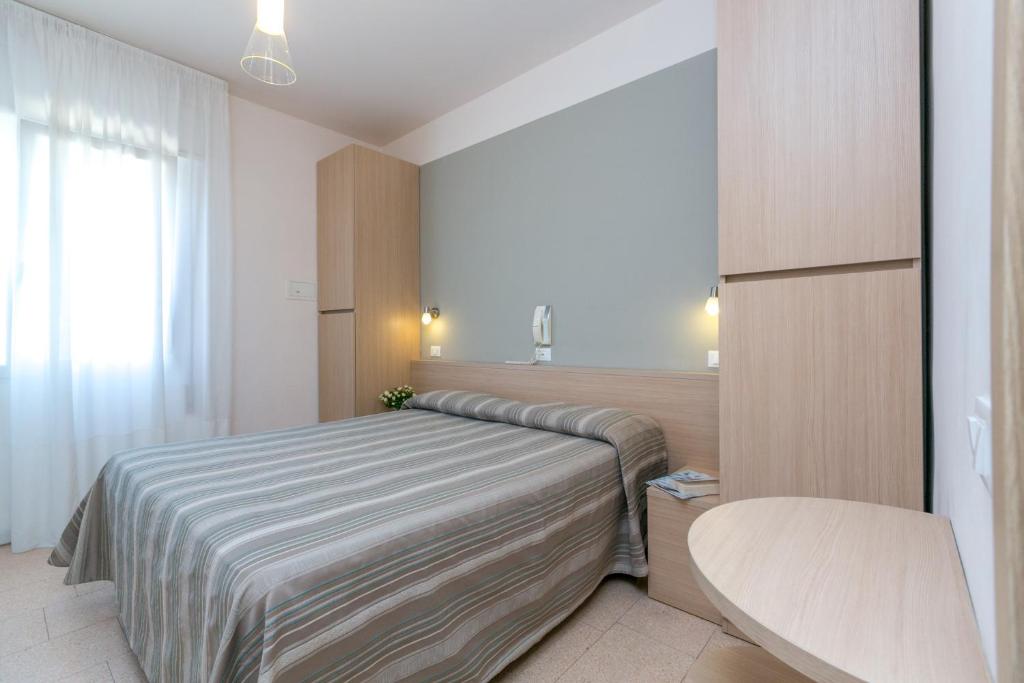 Postel nebo postele na pokoji v ubytování Hotel Colonna