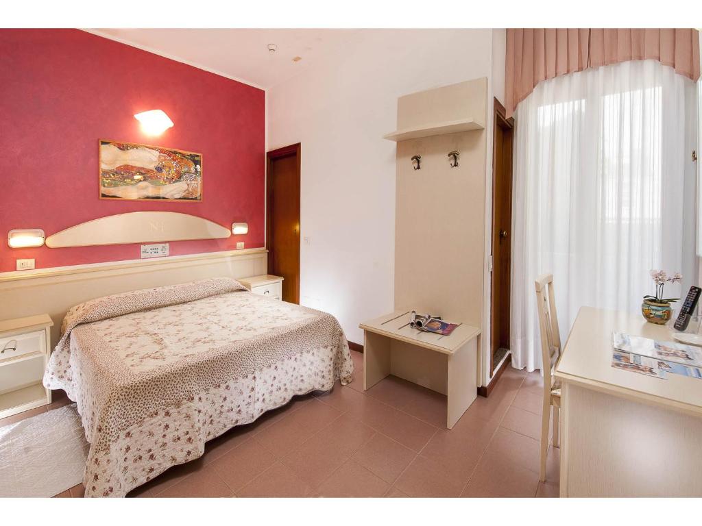 Postel nebo postele na pokoji v ubytování Hotel Napoleon