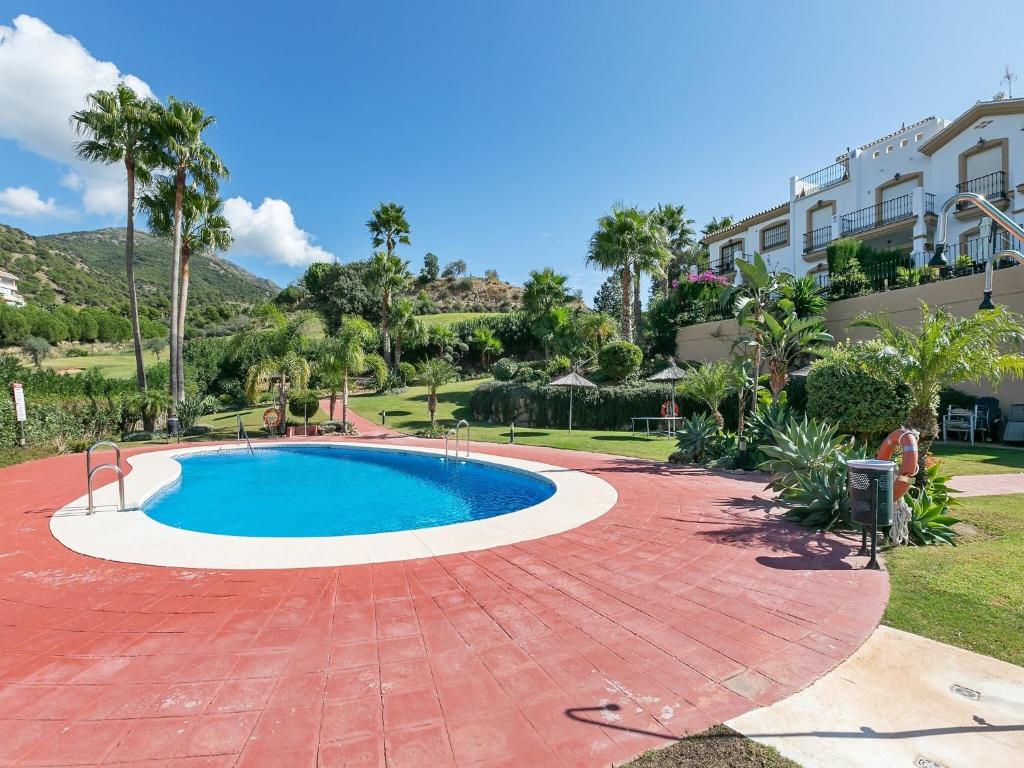 a swimming pool in the middle of a red brick patio at Alhaurín Villa with Terrace in Alhaurín el Grande