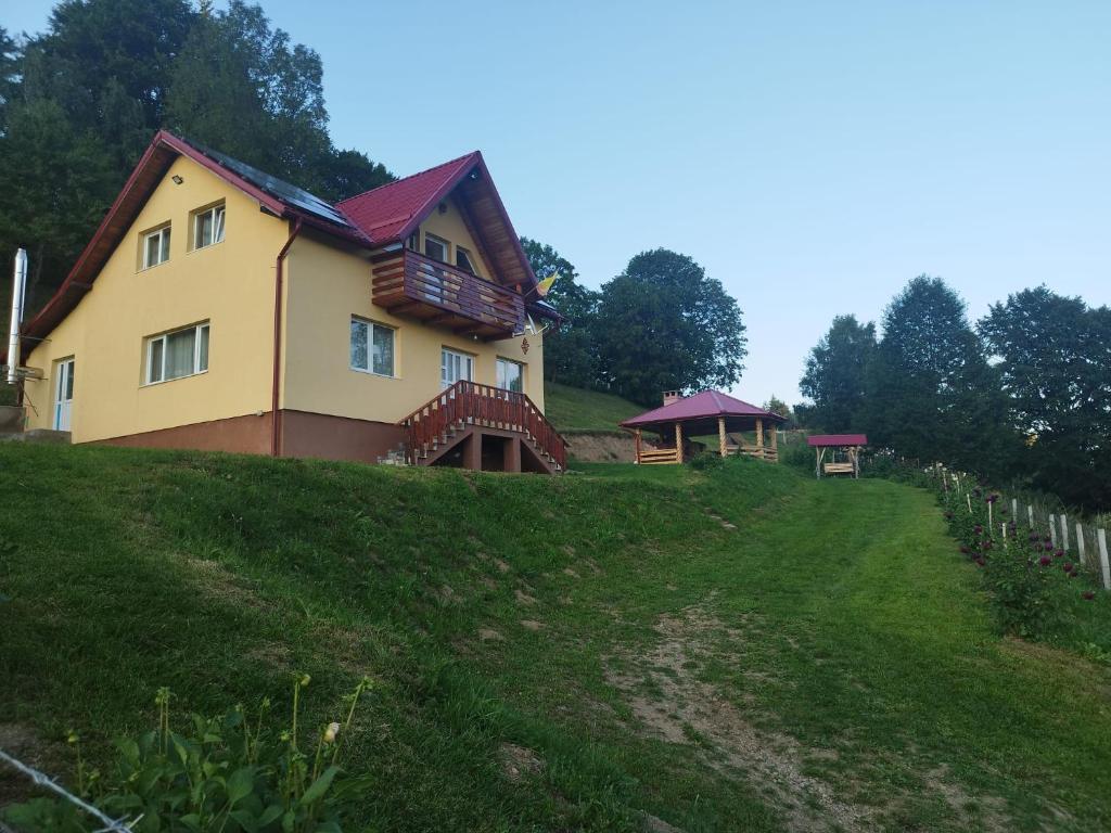 a house on the side of a hill at Casa MAN in Mărişel