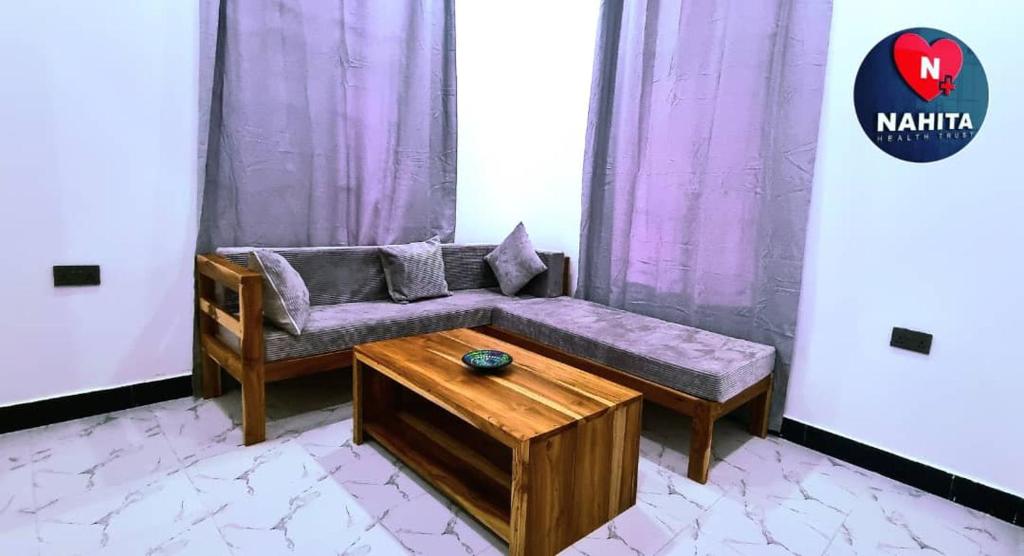 a living room with a couch and a table at Nahita Apartment in Kibigija