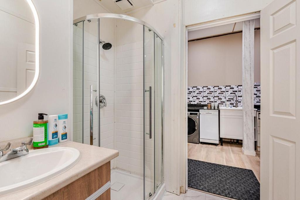 a bathroom with a shower and a sink at Great 1BR Apartment near VIA Rail in London