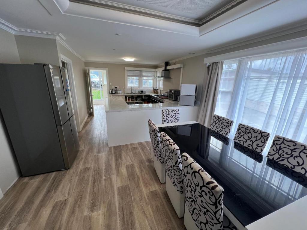 a kitchen with a counter and chairs in a room at Happy Haven Lodge I Shared Rooms in Newnham