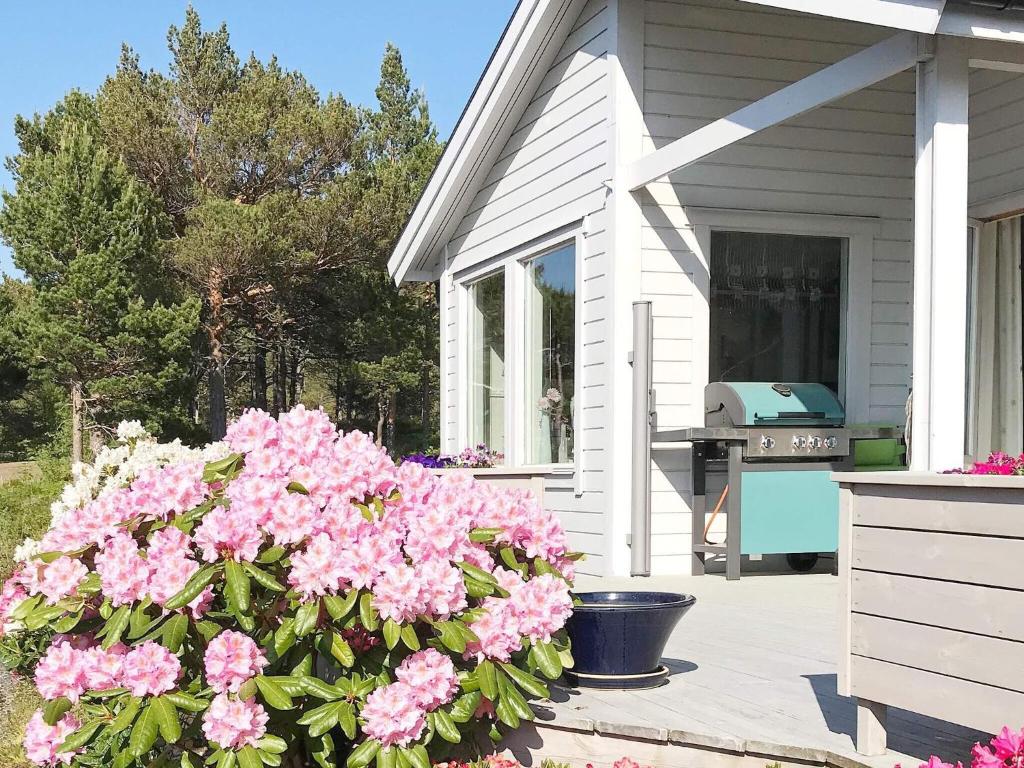 a bunch of pink flowers in front of a house at 6 person holiday home in Aure-By Traum in Aure