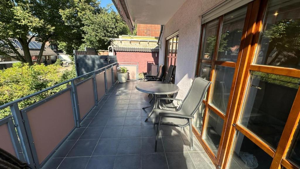 a balcony with a table and chairs on it at Ferienhaus "Rommelhäuser" in Nidderau