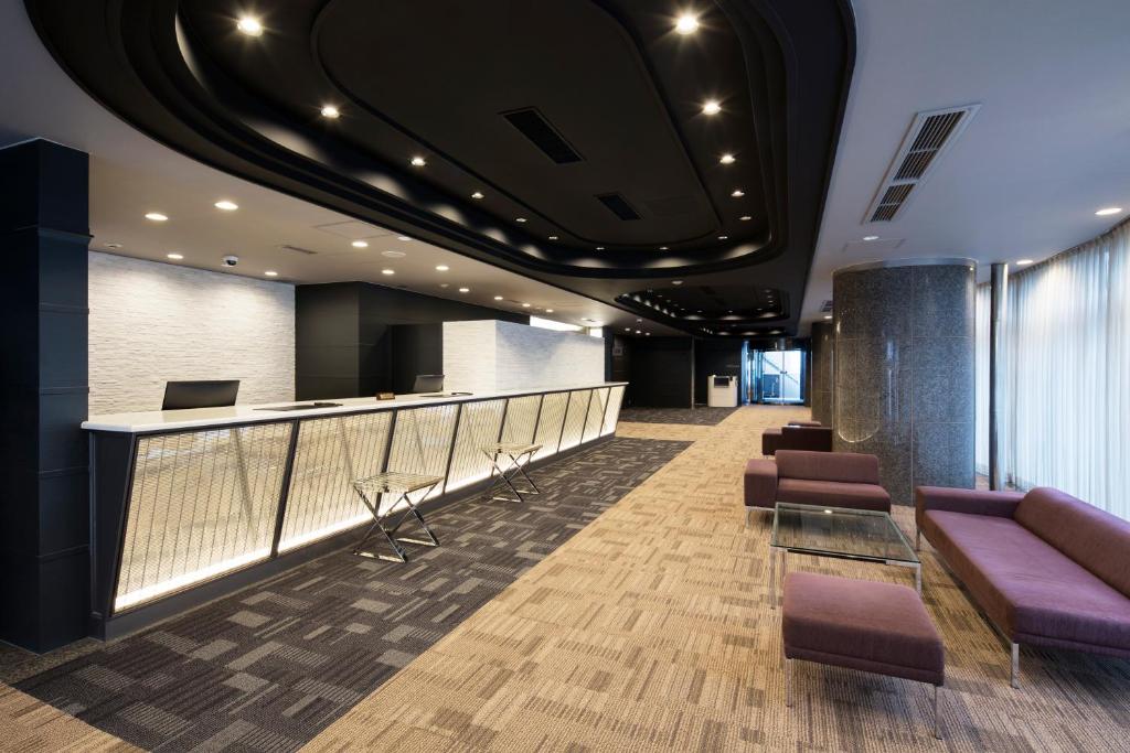 a lobby with purple furniture and a bar at HOTEL MYSTAYS Tachikawa in Tachikawa