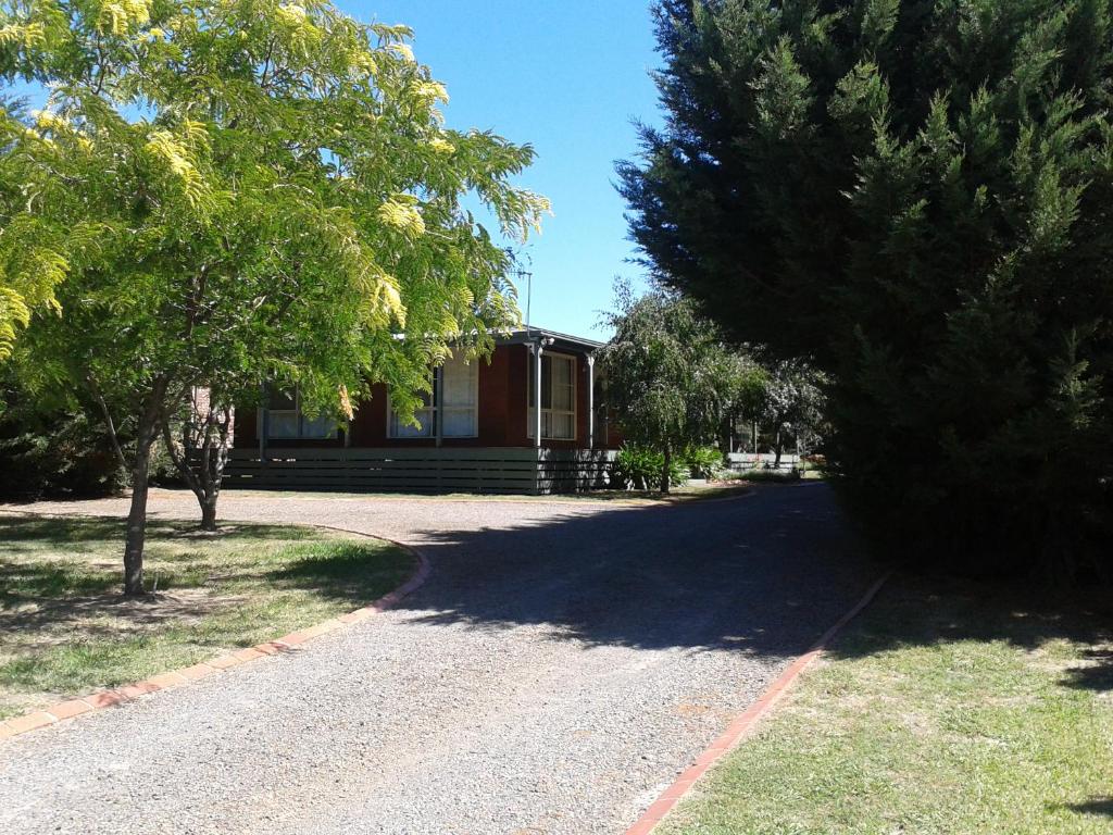 a house on a road in front of a building at Sunburst Retreat in Eildon