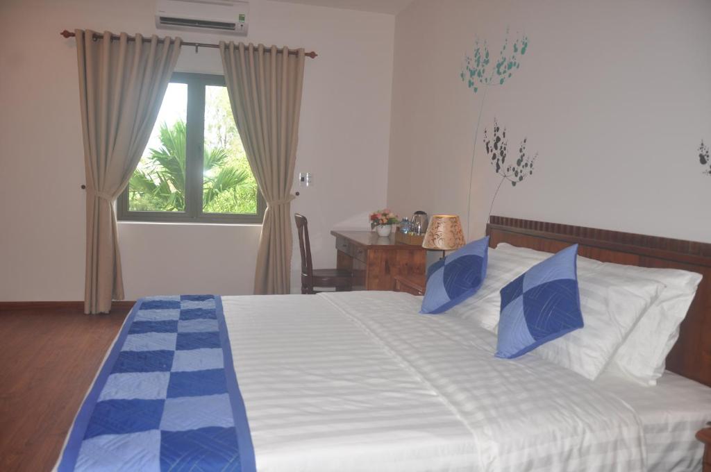 Postel nebo postele na pokoji v ubytování Tra Que Riverside Homestay