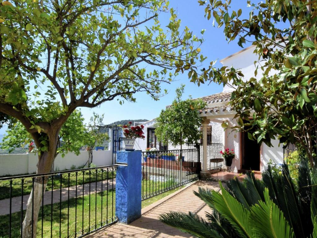 a house with a fence and a tree at Holiday Home in Zagrilla Alta with Pool in Zagrilla