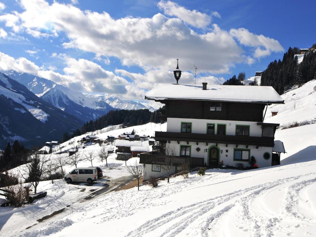 a building on top of a snow covered mountain at Apartment in Hollersbach near Ski Slopes in Bramberg am Wildkogel
